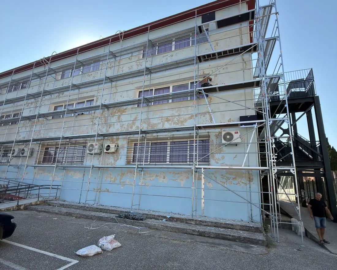 Scaffolding running the full length of a three-storey school building under renovation